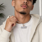 iced out goat pendant shown indoors modeled in natural environment