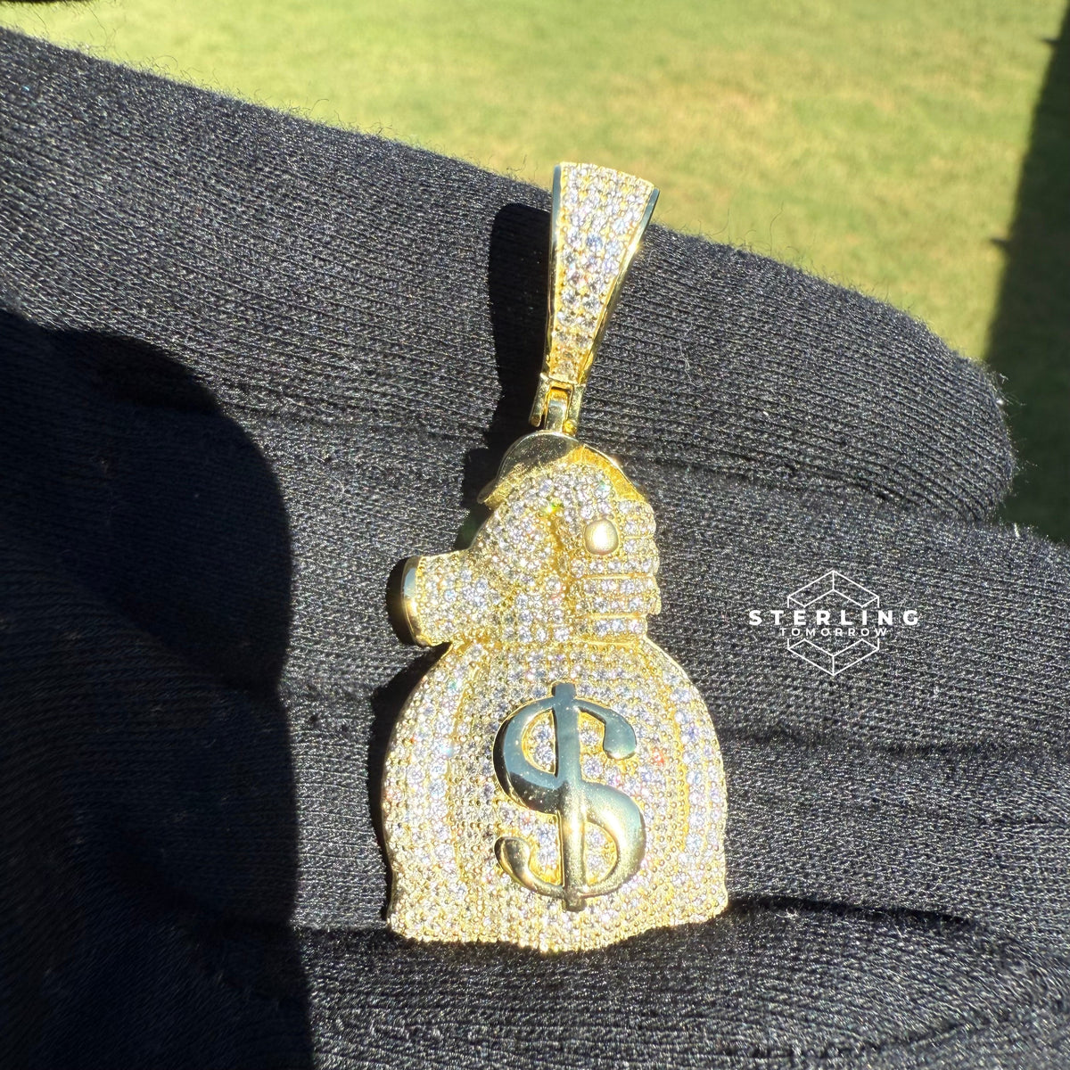 Gripping Moneybag Gold Tone CZ Pendant